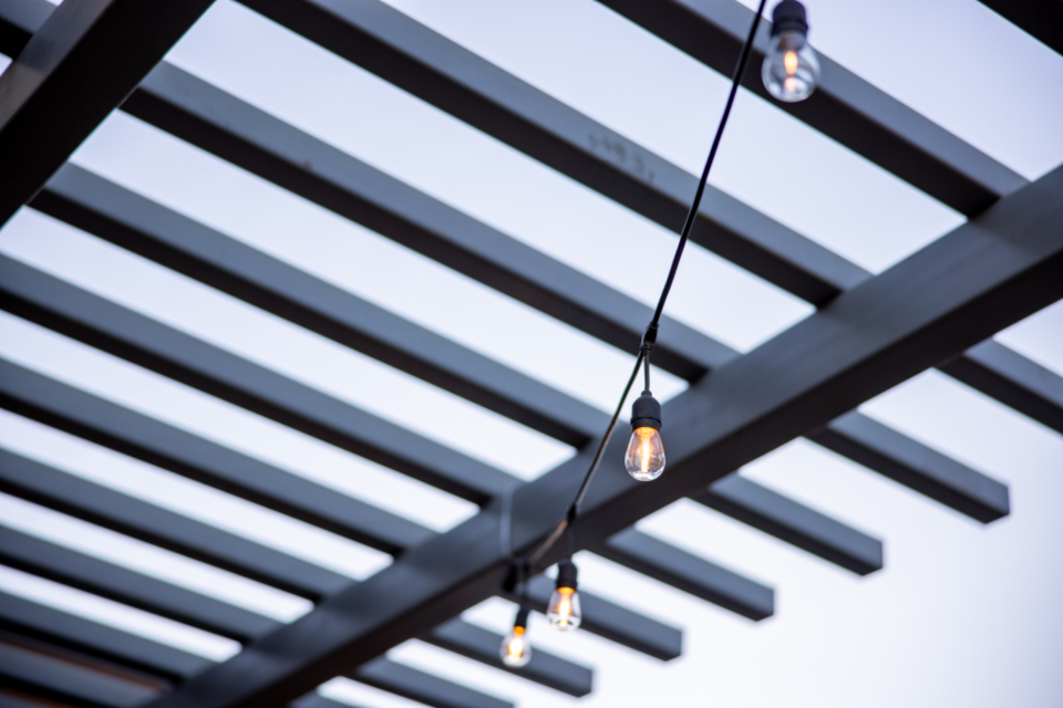 Festoon lighting strung above an outdoor event space